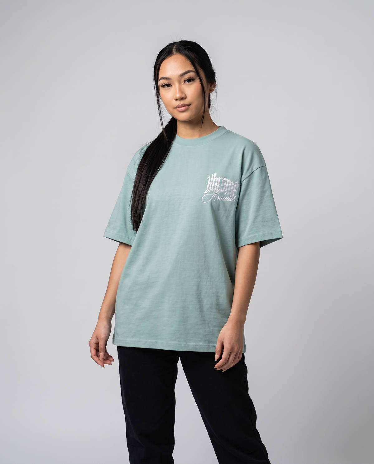 Teal Minimarisuto Sakura T-Shirt by KHROME AISUAUTO worn by a model, front view with chest logo