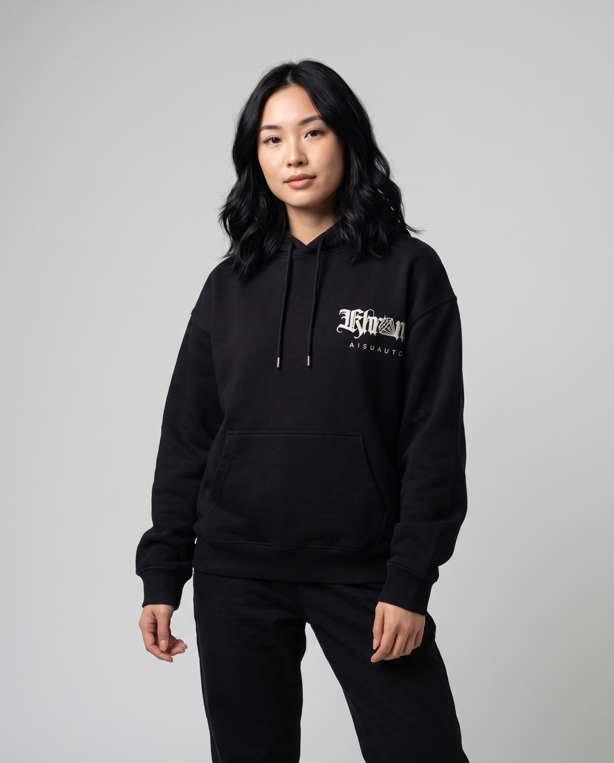 Black Sakurasheniru Hoodie by KHROME AISUAUTO worn by a model, front view with chest logo