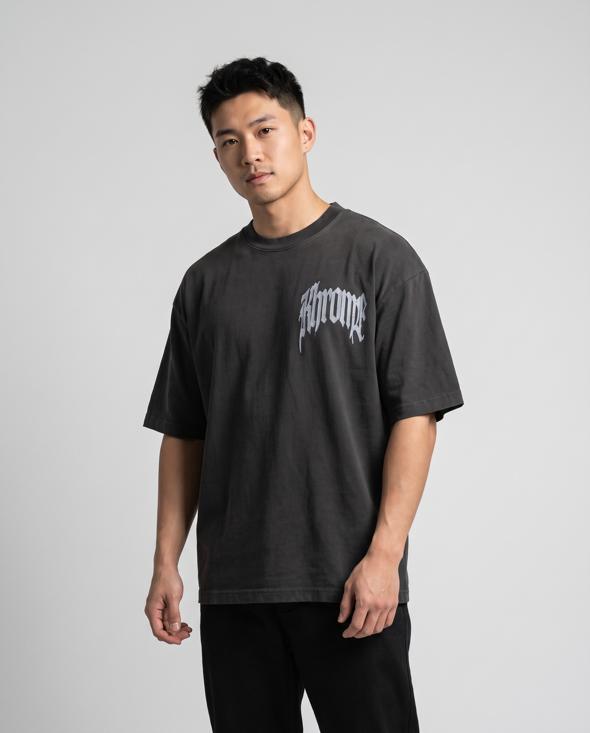 Faded Black Urban Street T-Shirt by KHROME AISUAUTO worn by a model, front view with chest logo