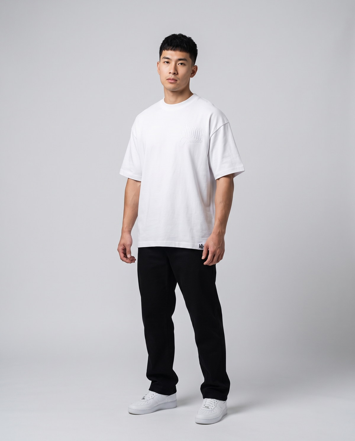 White Minimarisuto T-Shirt by KHROME AISUAUTO worn by a model, front view with chest logo