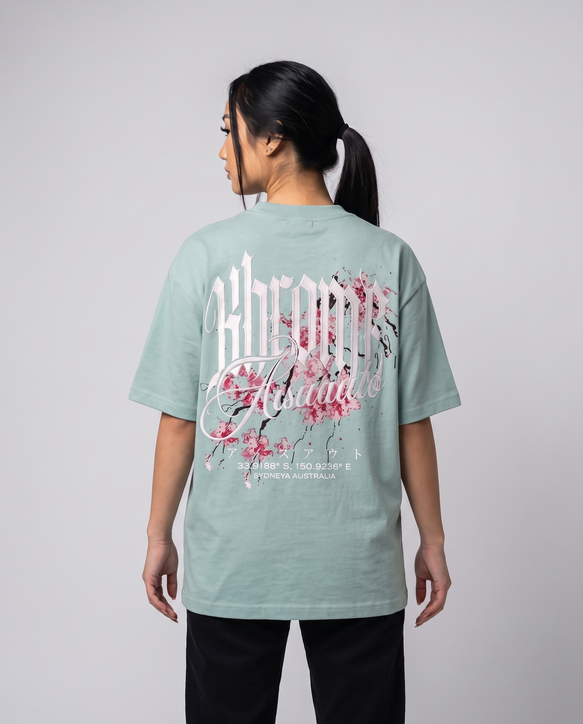 Teal Minimarisuto Sakura T-Shirt by KHROME AISUAUTO worn by a model, back view showing the full back print