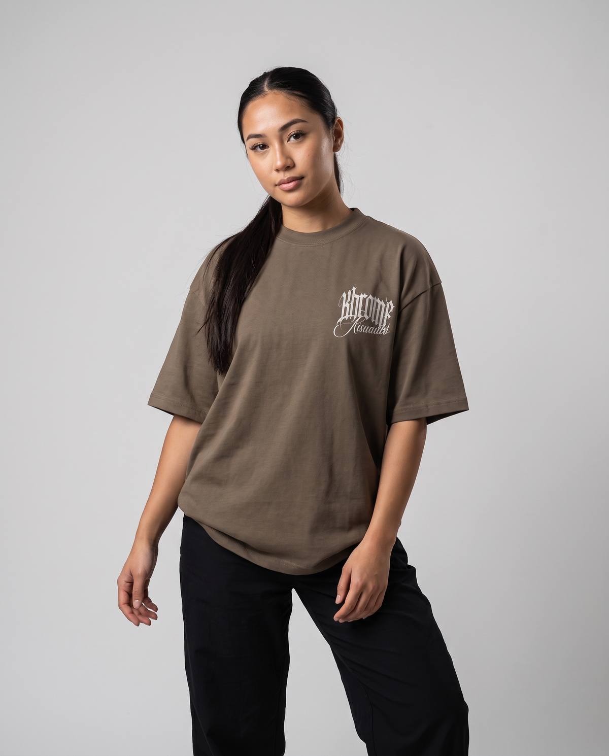 Walnut Minimarisuto T-Shirt by KHROME AISUAUTO worn by a model, front view with chest logo