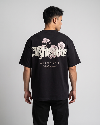 Black Sakurasheniru Blossom T-Shirt by KHROME AISUAUTO worn by a model, back view showing the full back print
