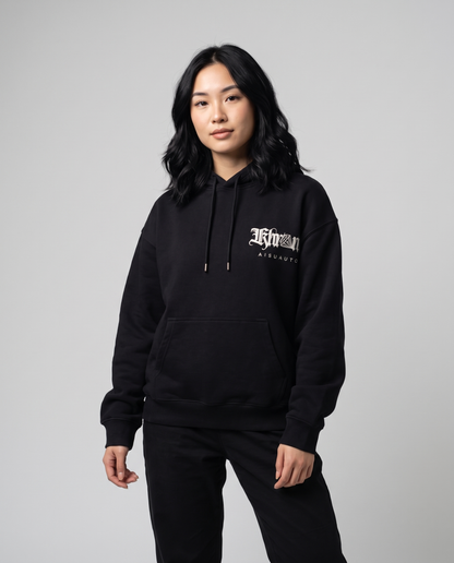 Black Sakurasheniru Hoodie by KHROME AISUAUTO worn by a model, front view with chest logo