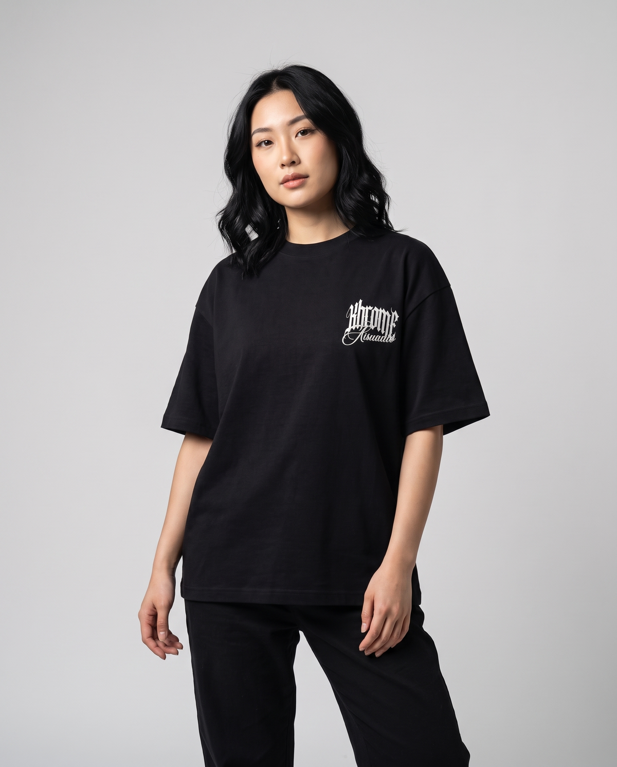 Black Minimarisuto T-Shirt by KHROME AISUAUTO worn by a model, front view with chest logo