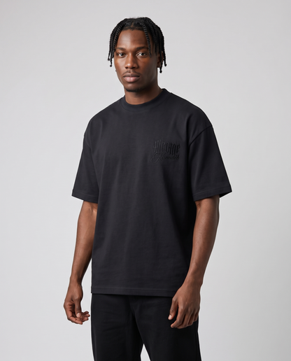 Black Minimarisuto T-Shirt Black On Black by KHROME AISUAUTO worn by a model, front view with chest logo