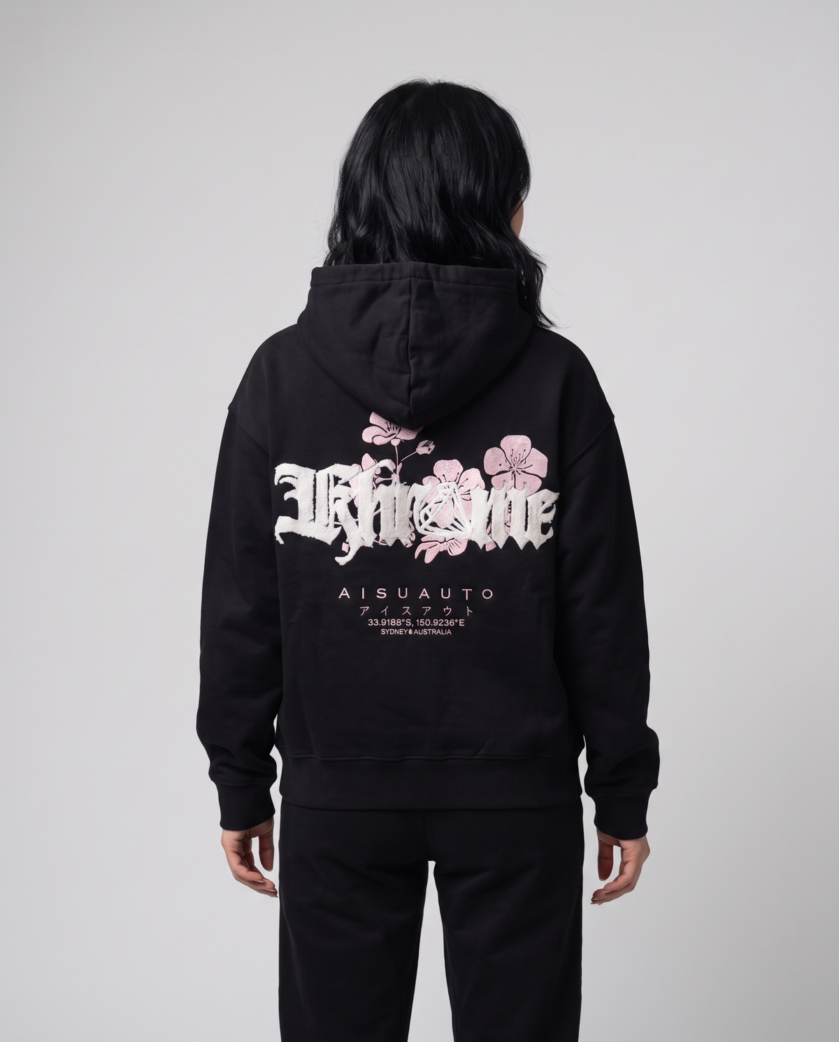 Black Sakurasheniru Hoodie by KHROME AISUAUTO worn by a model, back view showing the full back print