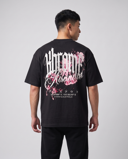 Black Minimarisuto Sakura T-Shirt by KHROME AISUAUTO worn by a model, back view showing the full back print