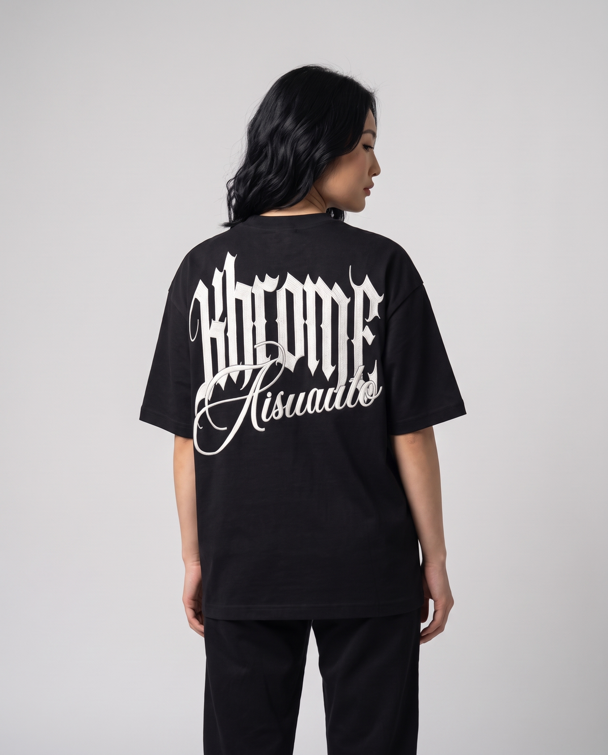 Black Minimarisuto T-Shirt by KHROME AISUAUTO worn by a model, back view showing the full back print