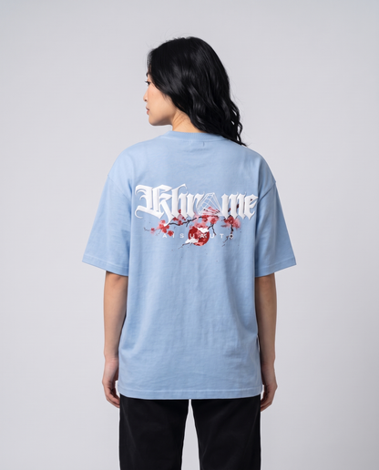 Baby Blue Kuromu Sakura T-Shirt by KHROME AISUAUTO worn by a model, back view showing the full back print