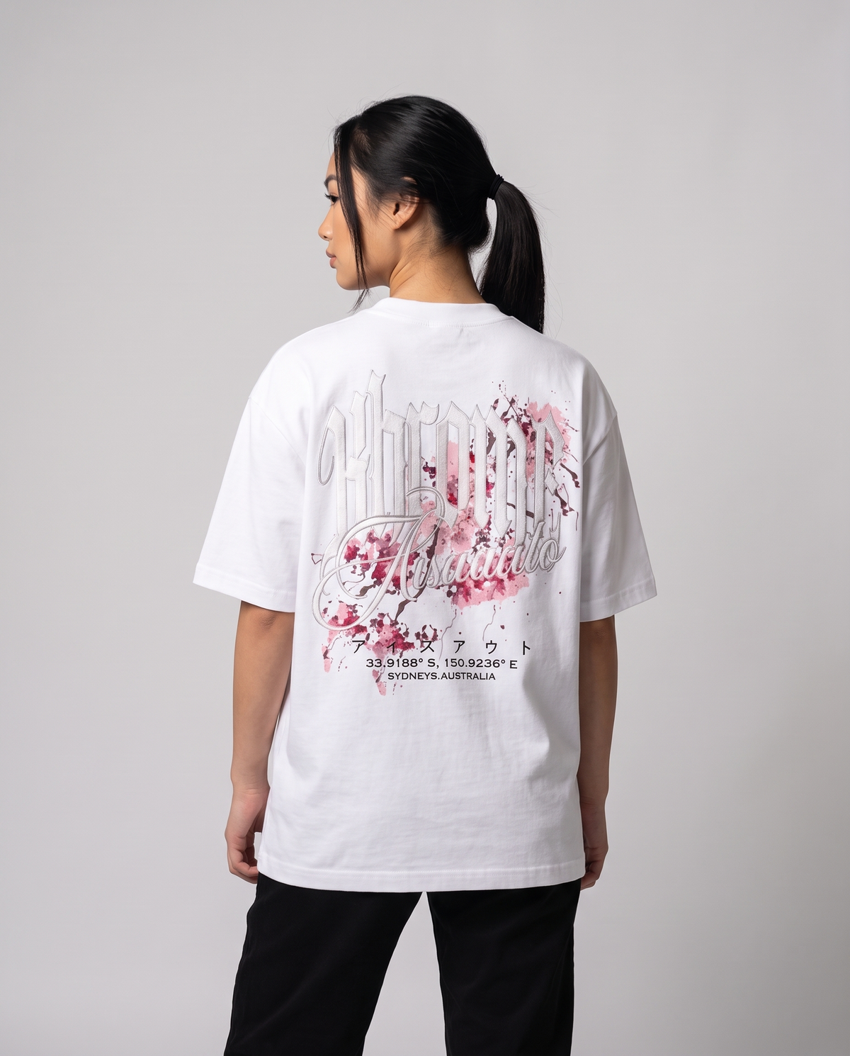 White Minimarisuto Sakura T-Shirt by KHROME AISUAUTO worn by a model, back view showing the full back print