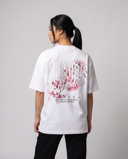 White Minimarisuto Sakura T-Shirt by KHROME AISUAUTO worn by a model, back view showing the full back print