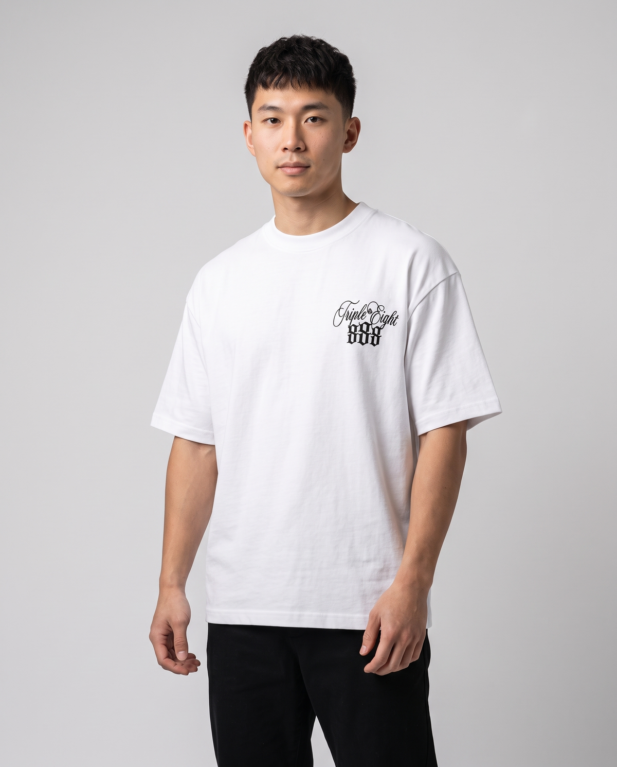 White Triple Eight T-Shirt by KHROME AISUAUTO worn by a model, front view with chest logo