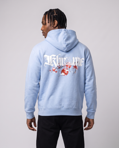 Baby Blue Kuromu Sakura Hoodie by KHROME AISUAUTO worn by a model, back view showing the full back print