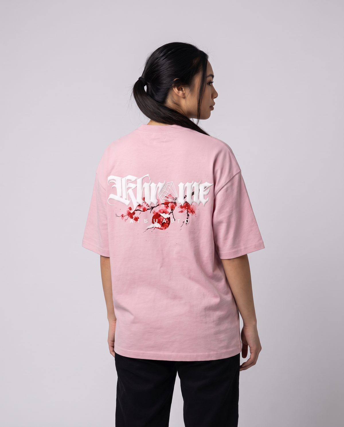 Baby Pink Kuromu Sakura T-Shirt by KHROME AISUAUTO worn by a model, back view showing the full back print