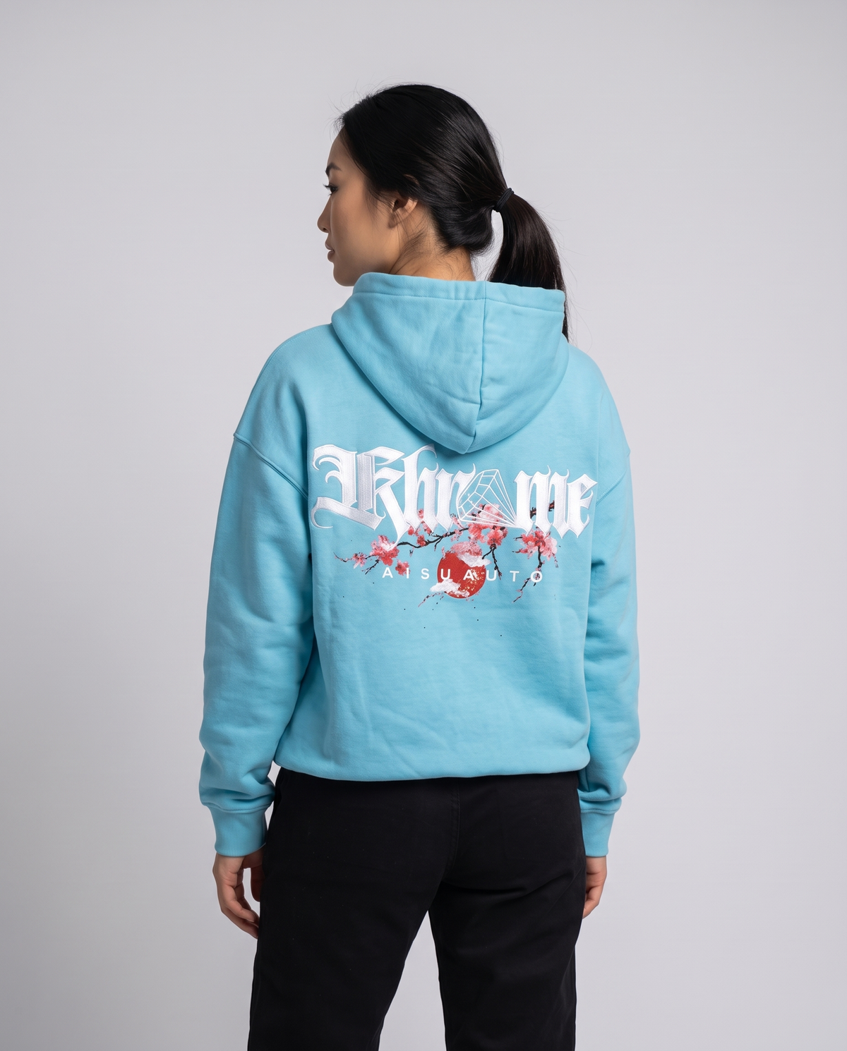 Tiffany Blue Kuromu Sakura Hoodie by KHROME AISUAUTO worn by a model, back view showing the full back print